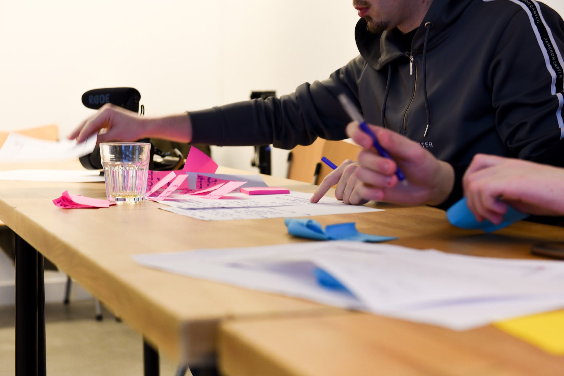 Students working through ideas with sticky notes and marker pens at a sprint table