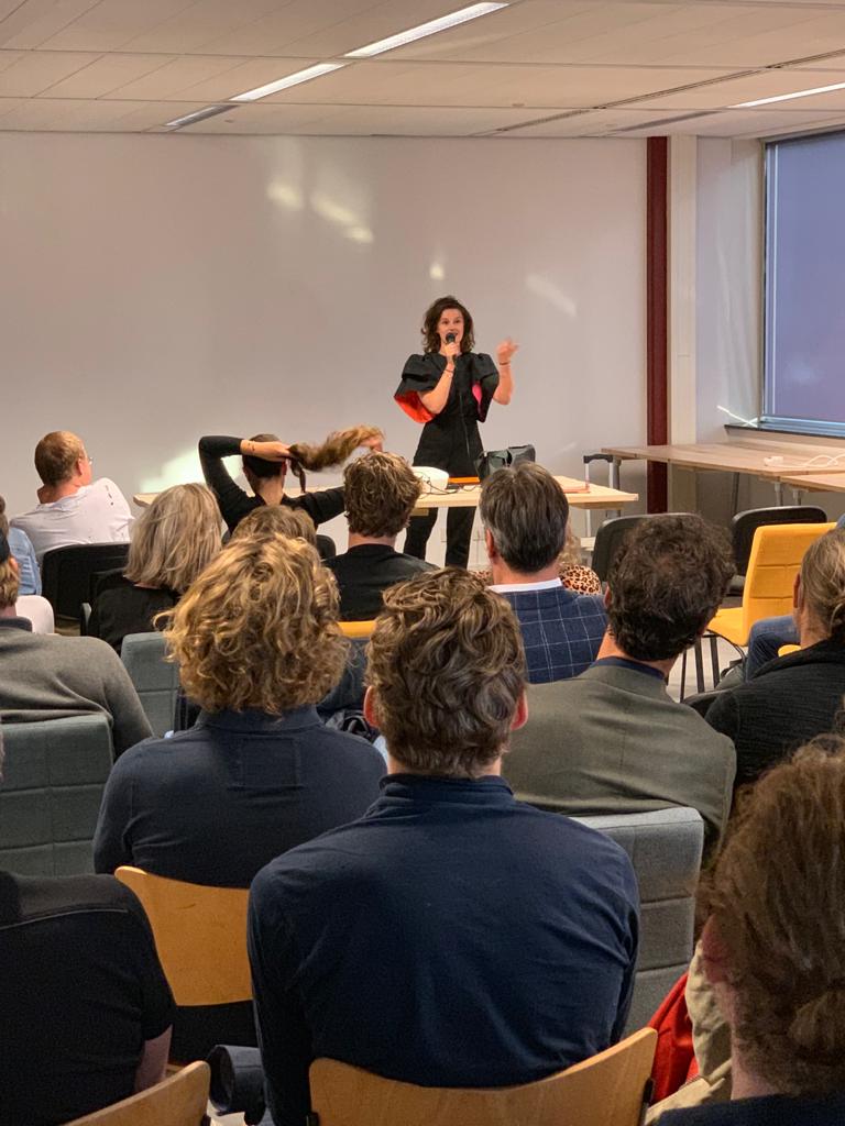 A speaker presenting to a packed room of students and founders