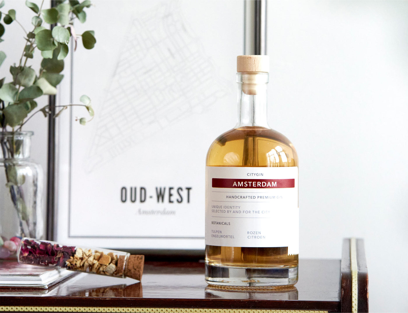 City Gin Amsterdam bottle styled beside an Oud-West city map print