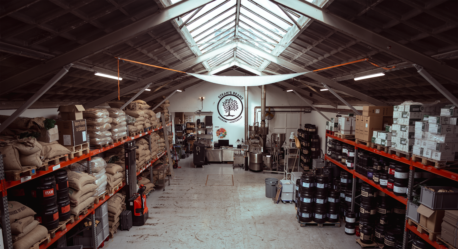 Stean’s Beans roastery in Amsterdam with sacks of green coffee and roasting equipment