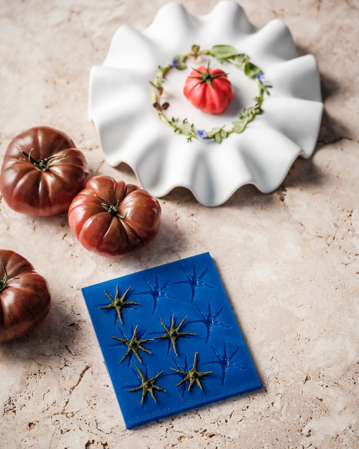 MoldBrothers tomato-shaped plated dish with heirloom tomatoes and a blue silicone mould