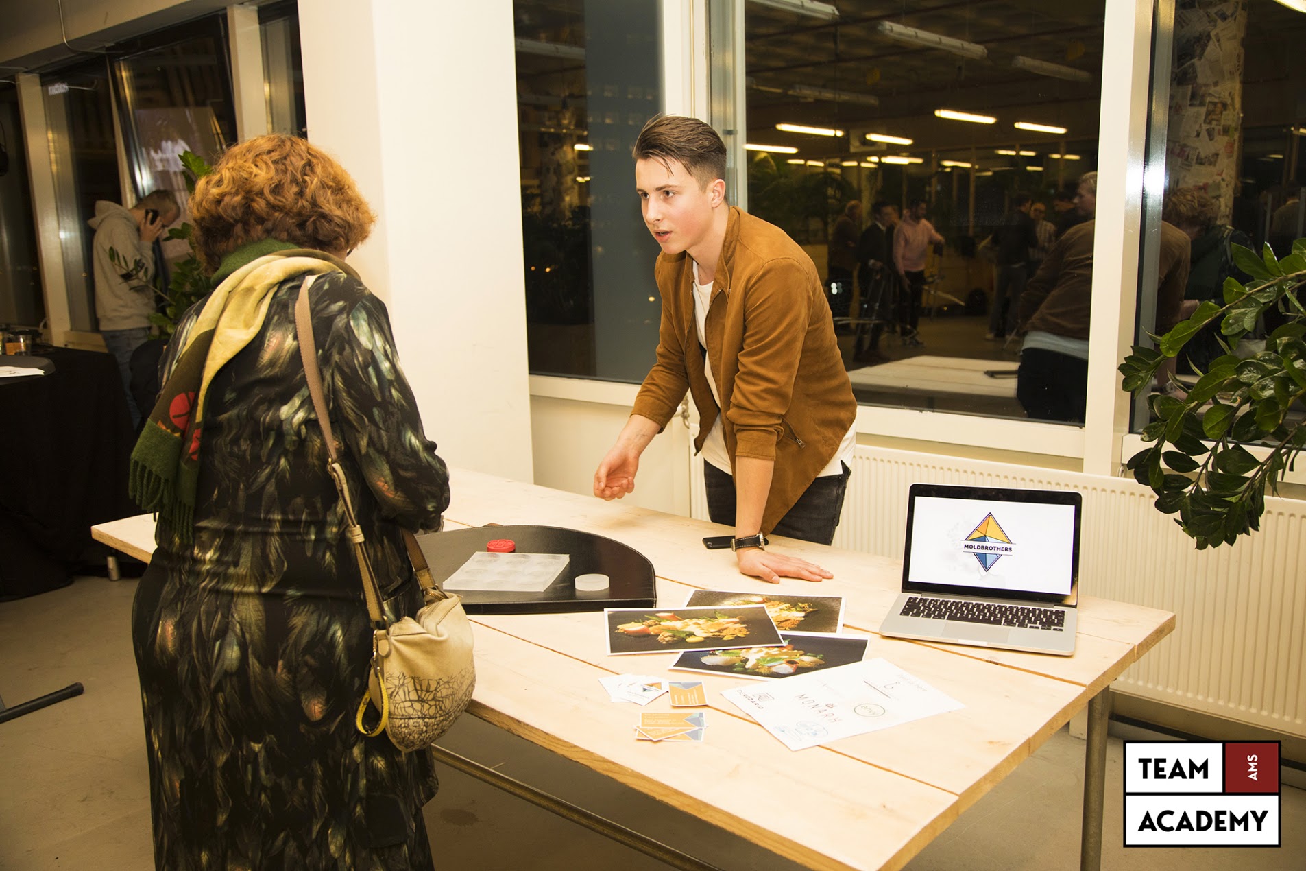 A student presenting the MoldBrothers venture to a visitor at a market day