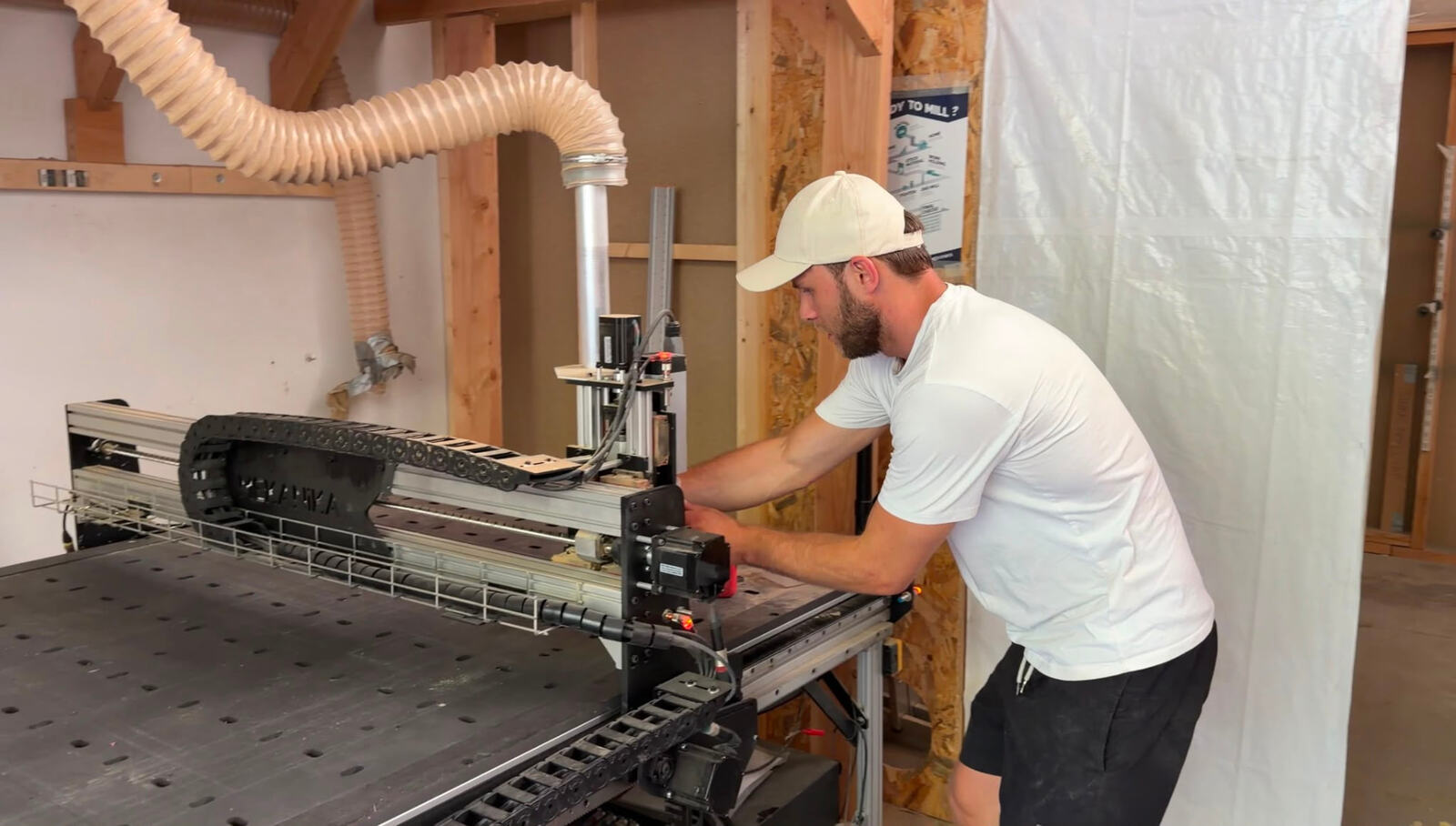 Normunds Vitols setting up a cut at the CNC table in the MC Studio workshop